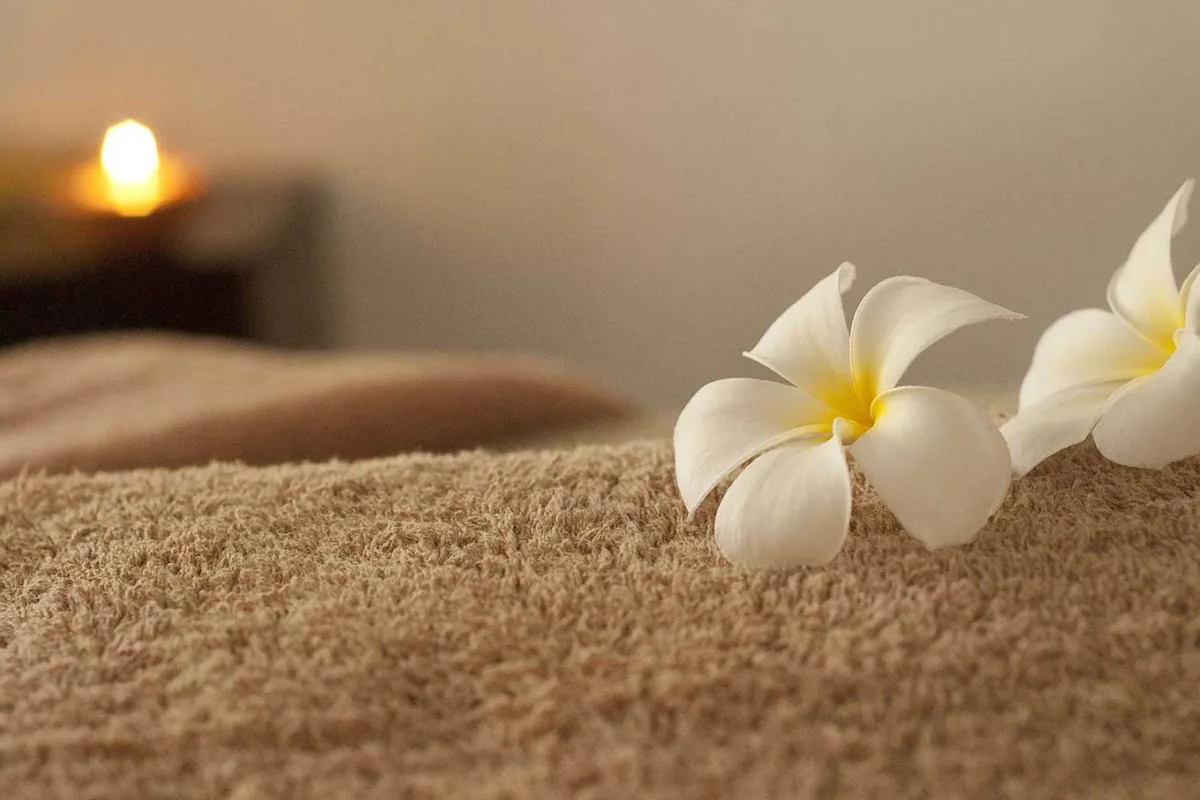Holistic relaxation massage atmosphere with warm spa lighting